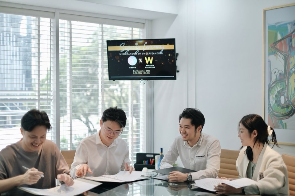 Ribbon contract signing moment with partners